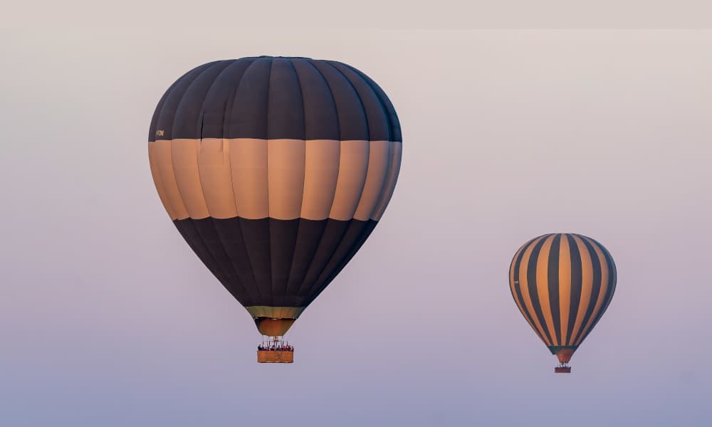 An image of two hot air balloons in the sky during daytime